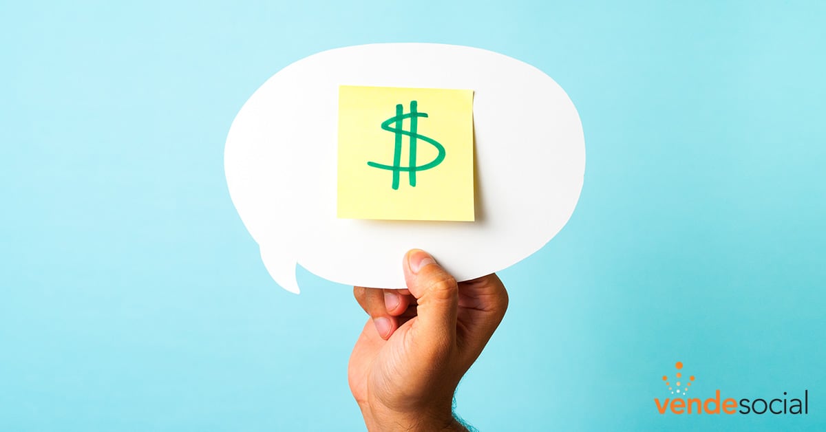 Person holding a speech bubble cutout with a sticky note on it. On the sticky note is a written dollar sign. | Digital Advertising Agency