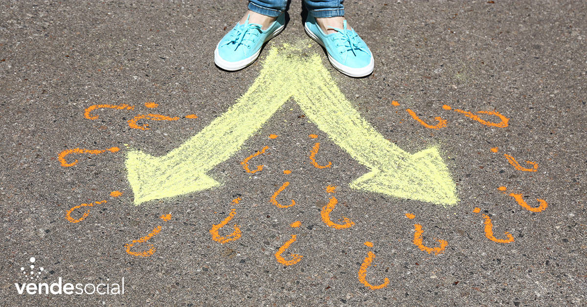 A person stands at the crossroads of two arrows drawn on the ground in chalk | create action from your leads